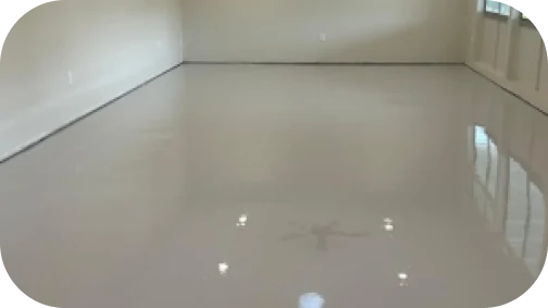 Glossy white solid epoxy floor in a modern space, offering a seamless and reflective finish.
